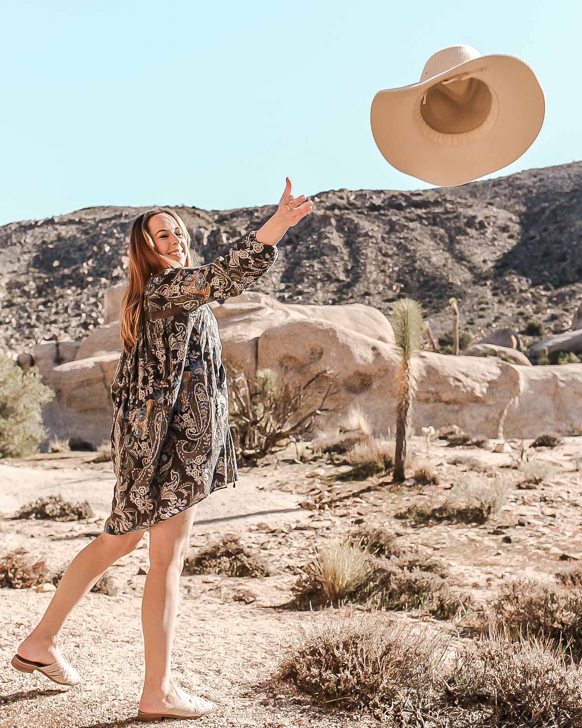 Rylie throwing her hat from San Diego Hat Company.