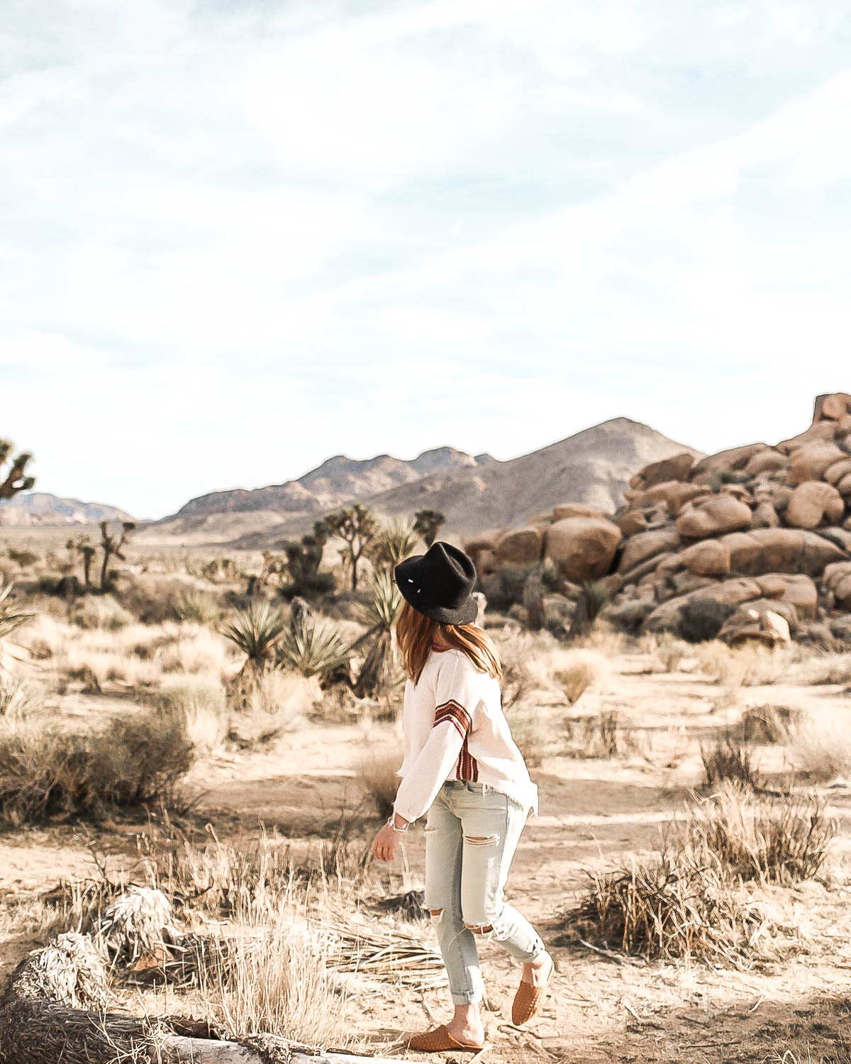 Rylie balancing on a log somewhere in the Joshua Tree desert.