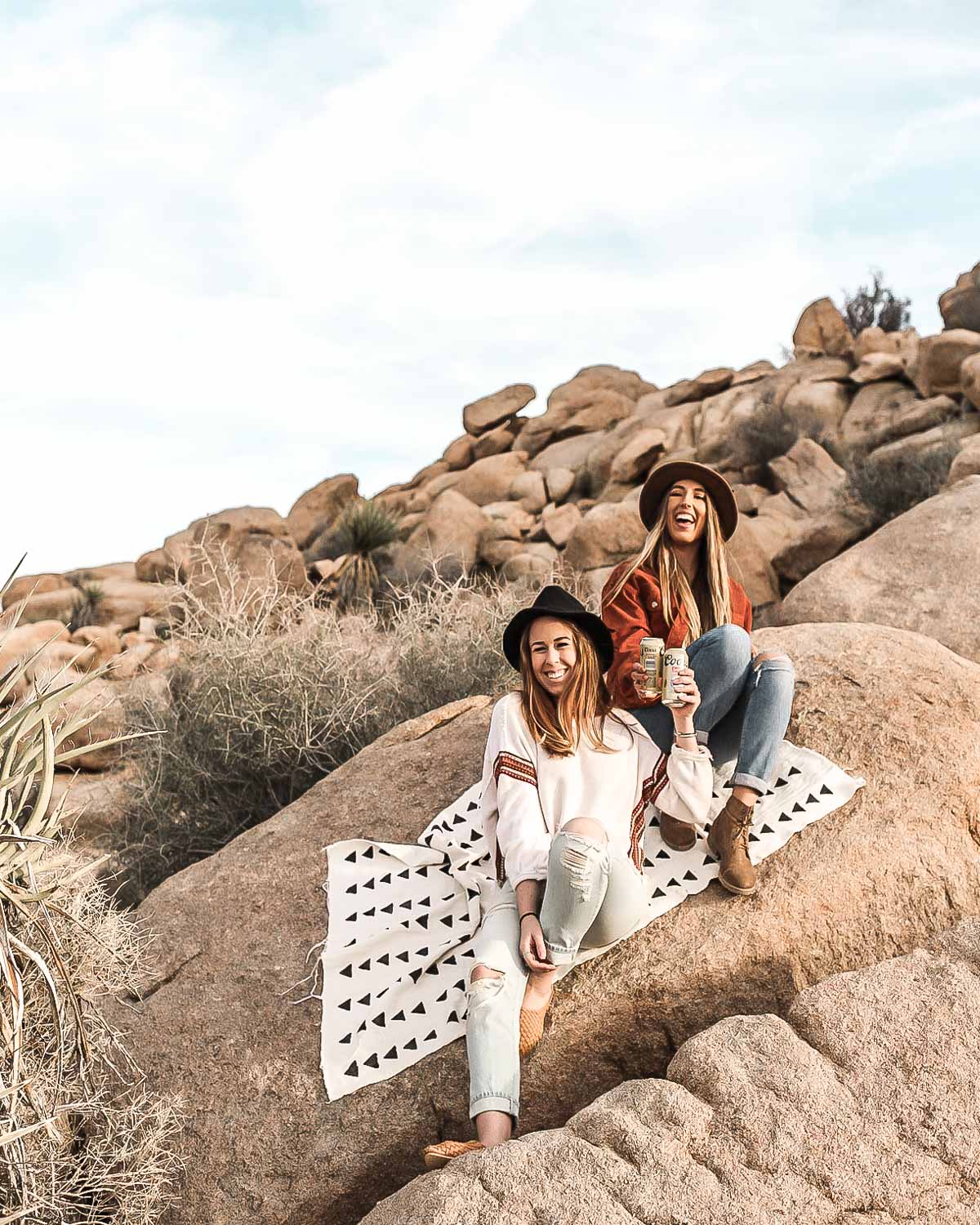 Rylie and her friend sitting on a rock near Ryan Mountain in Joshua Tree.